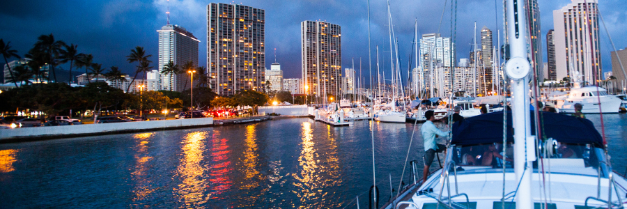 Picture of the Honolulu harbor at night from the deck of the yacht